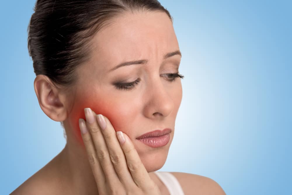 woman with tooth abscess pain